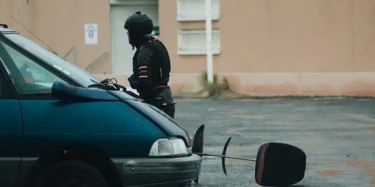 man in black helmet and black helmet riding on black car during daytime